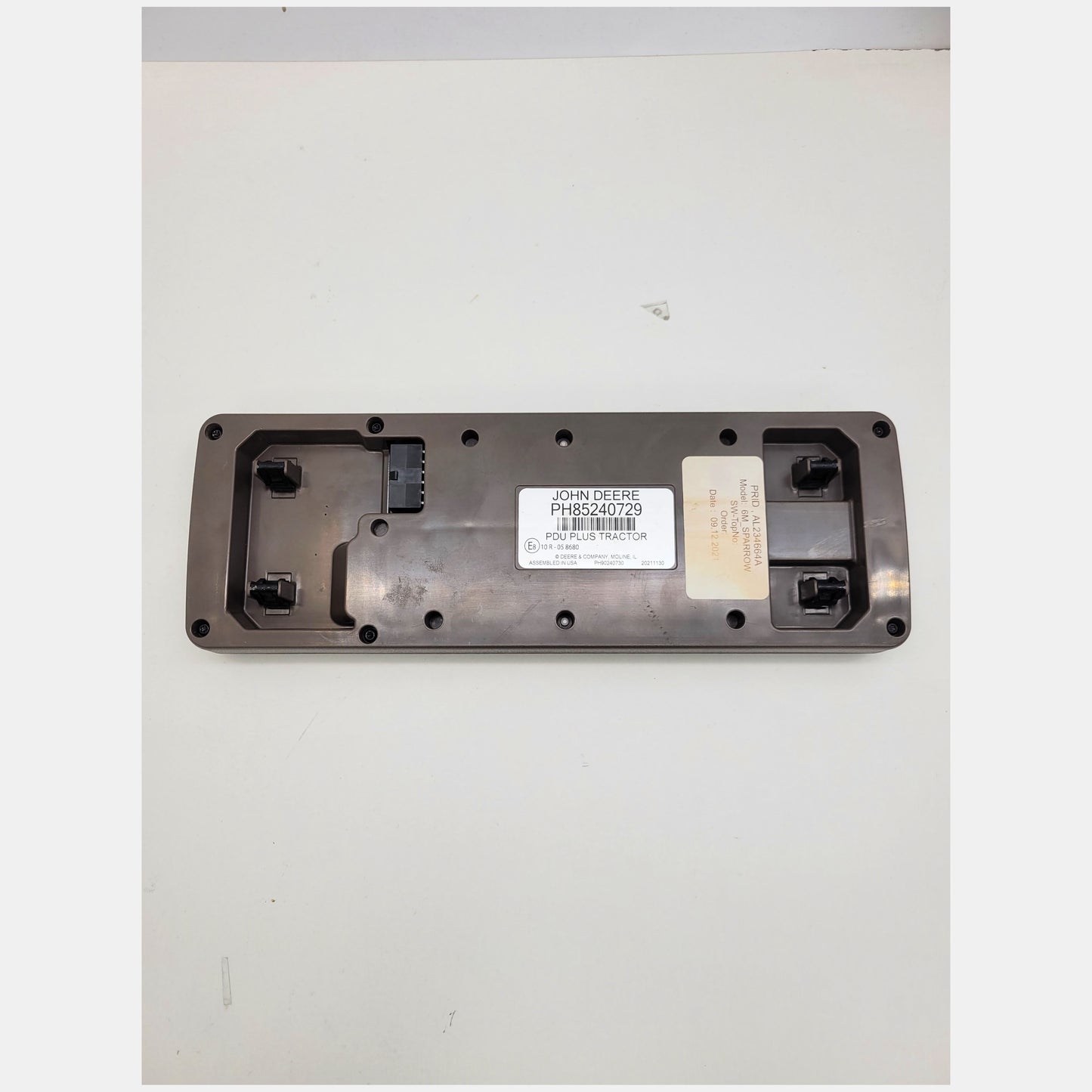 Rear view of John Deere PDU Plus tractor cluster PH85240729 showing OEM labels, part number AL234664A, and connector pins.