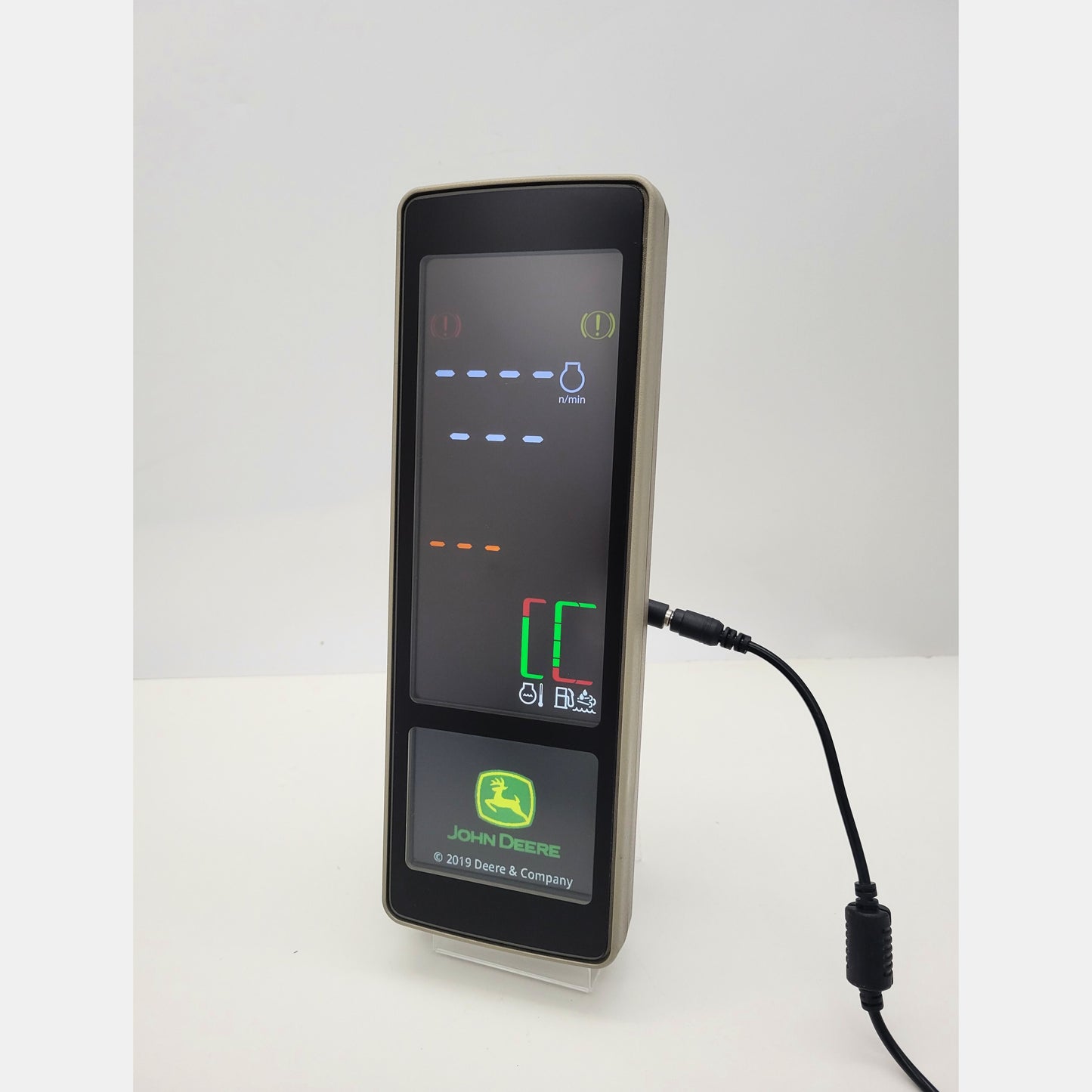 John Deere PDU Plus tractor dashboard display PH85240729 with active digital screen showing RPM and machine diagnostics.