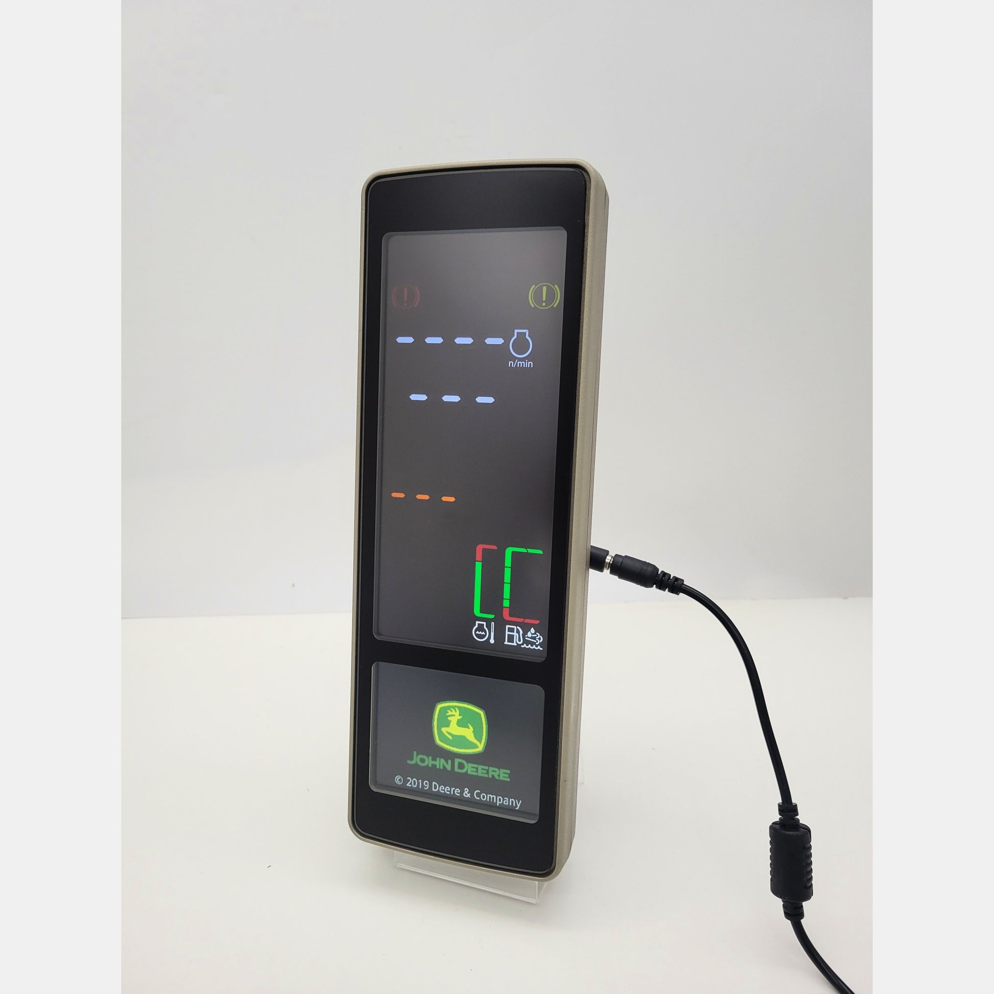 John Deere PDU Plus tractor dashboard display PH85240729 with active digital screen showing RPM and machine diagnostics.