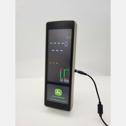 John Deere PDU Plus tractor dashboard display PH85240729 with active digital screen showing RPM and machine diagnostics.