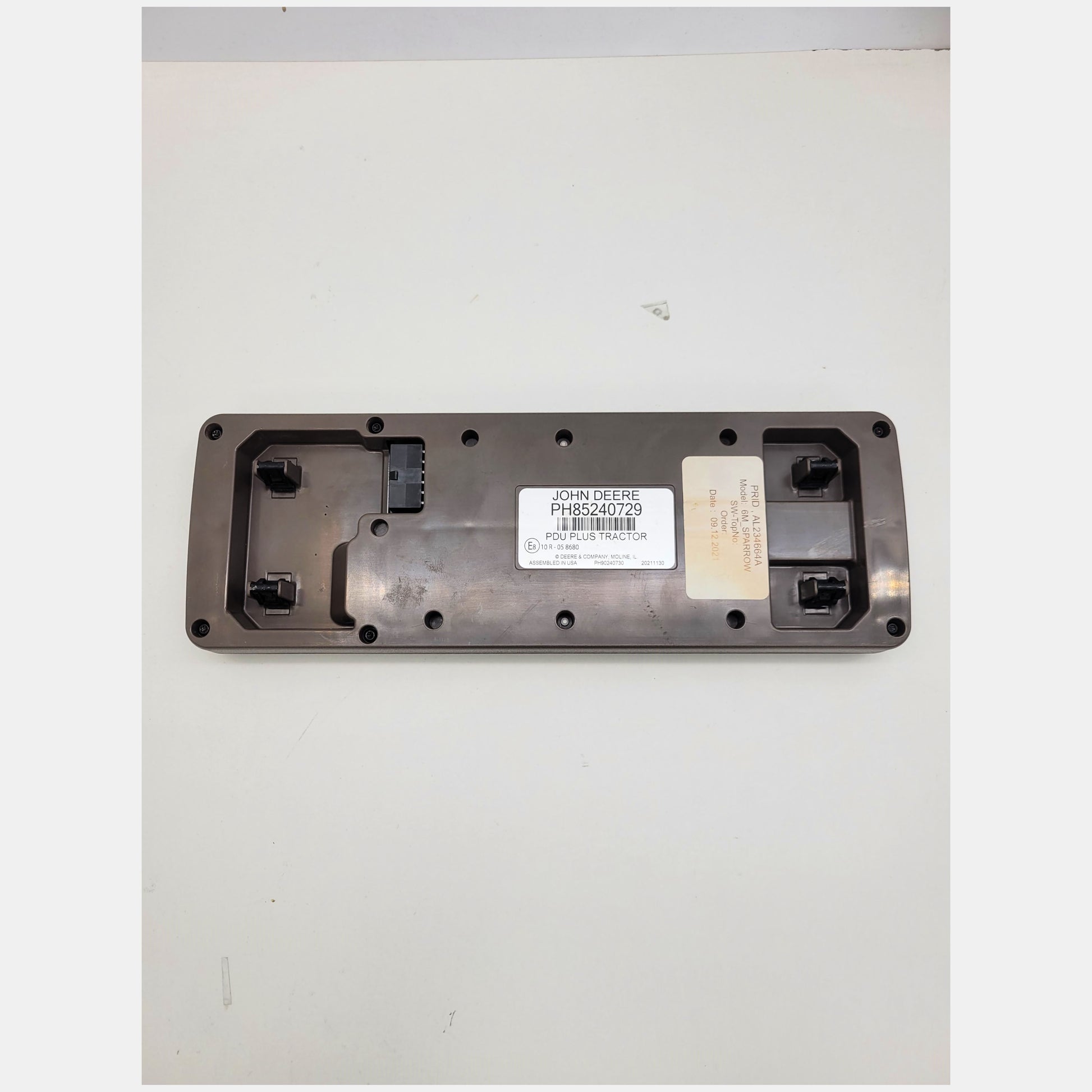 Rear view of John Deere PDU Plus tractor cluster PH85240729 showing OEM labels, part number AL234664A, and connector pins.
