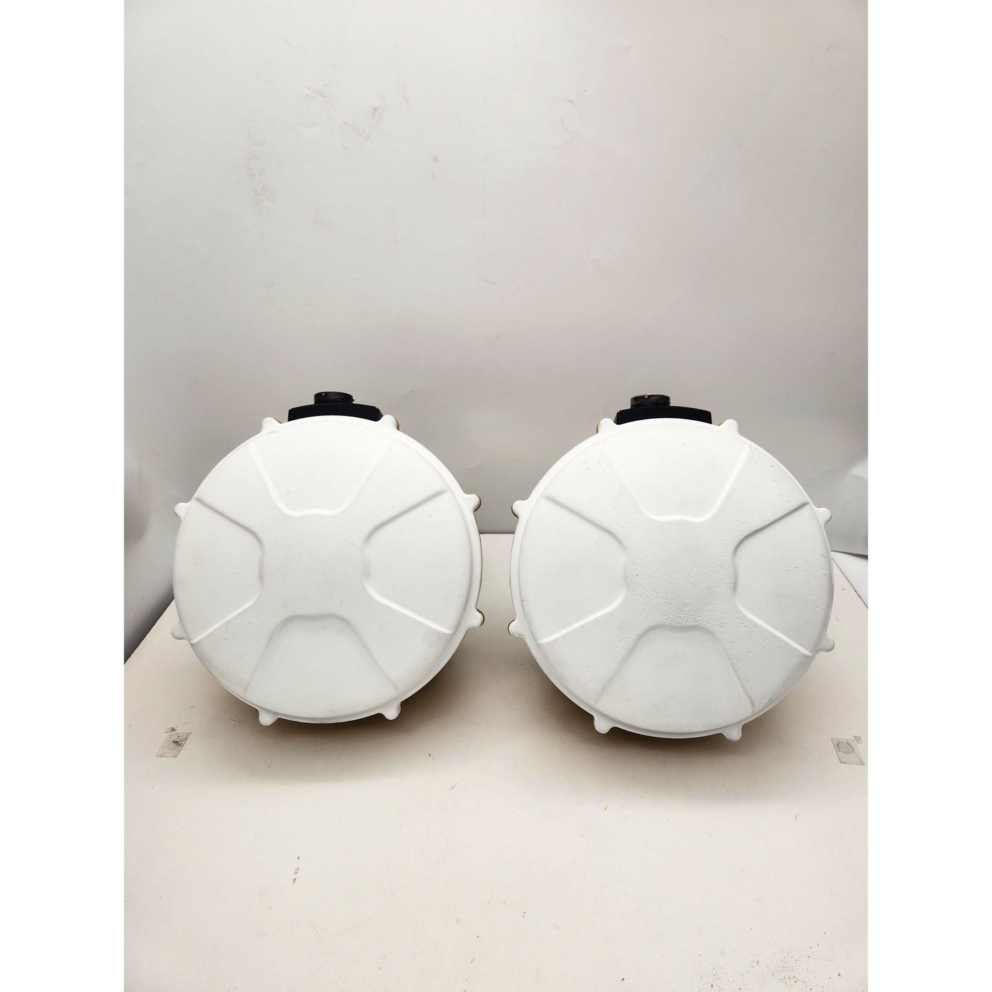 Top view of two CAT MS992 GNSS antennas with white radome covers, part of a dual-antenna 3D grading kit.